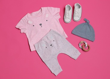 Photo of Flat lay composition with baby clothes and accessories on pink background