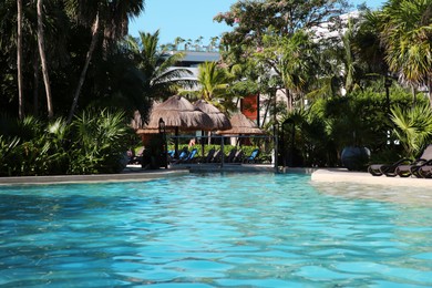 Photo of Outdoor swimming pool at resort on sunny day