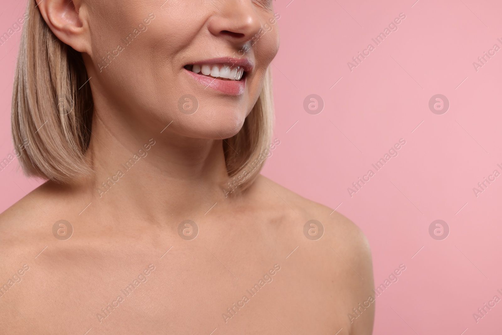 Photo of Woman with healthy skin on pink background, closeup