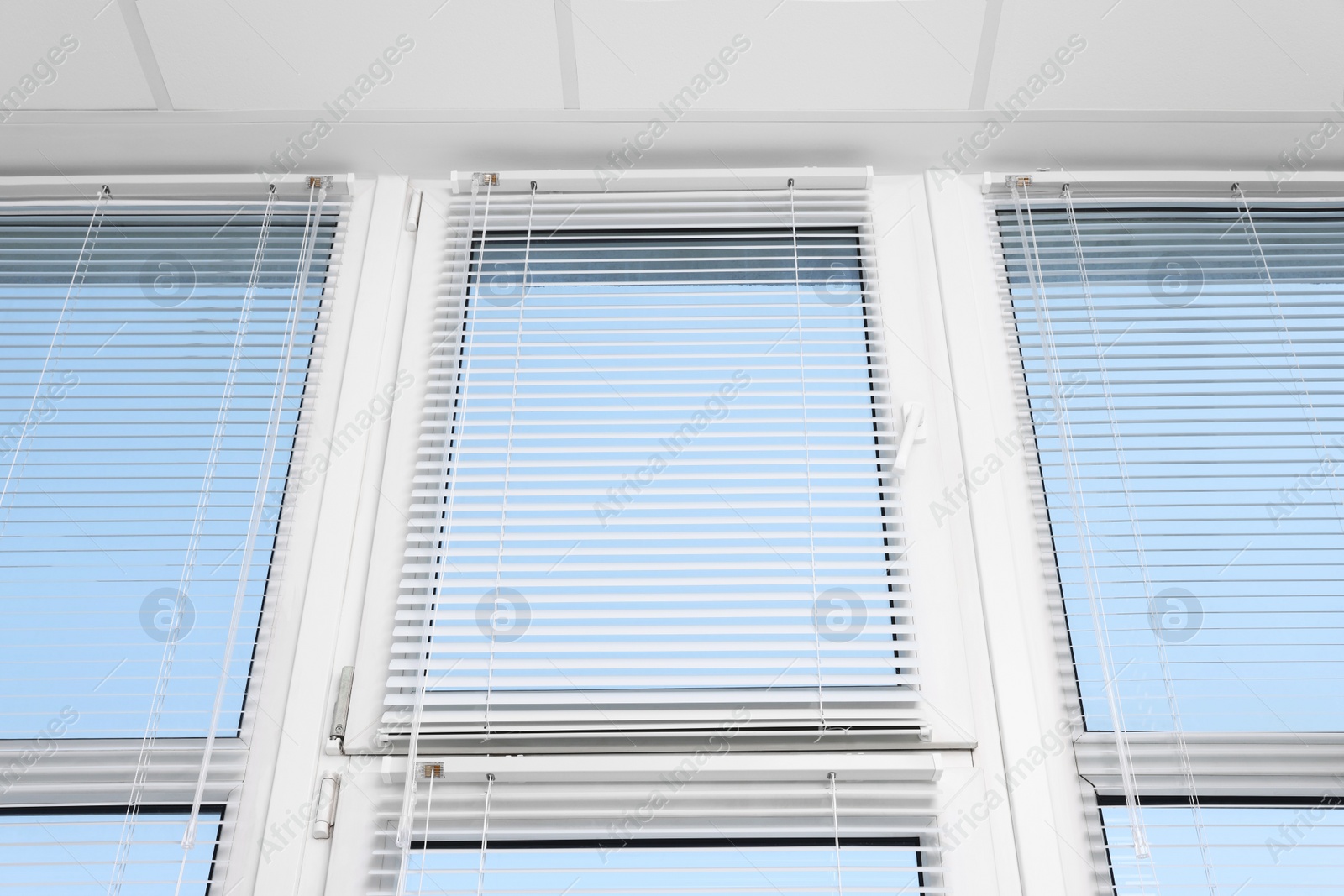 Photo of Large window with horizontal blinds indoors, low angle view