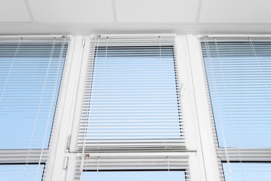 Photo of Large window with horizontal blinds indoors, low angle view