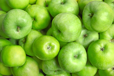 Fresh green apples as background