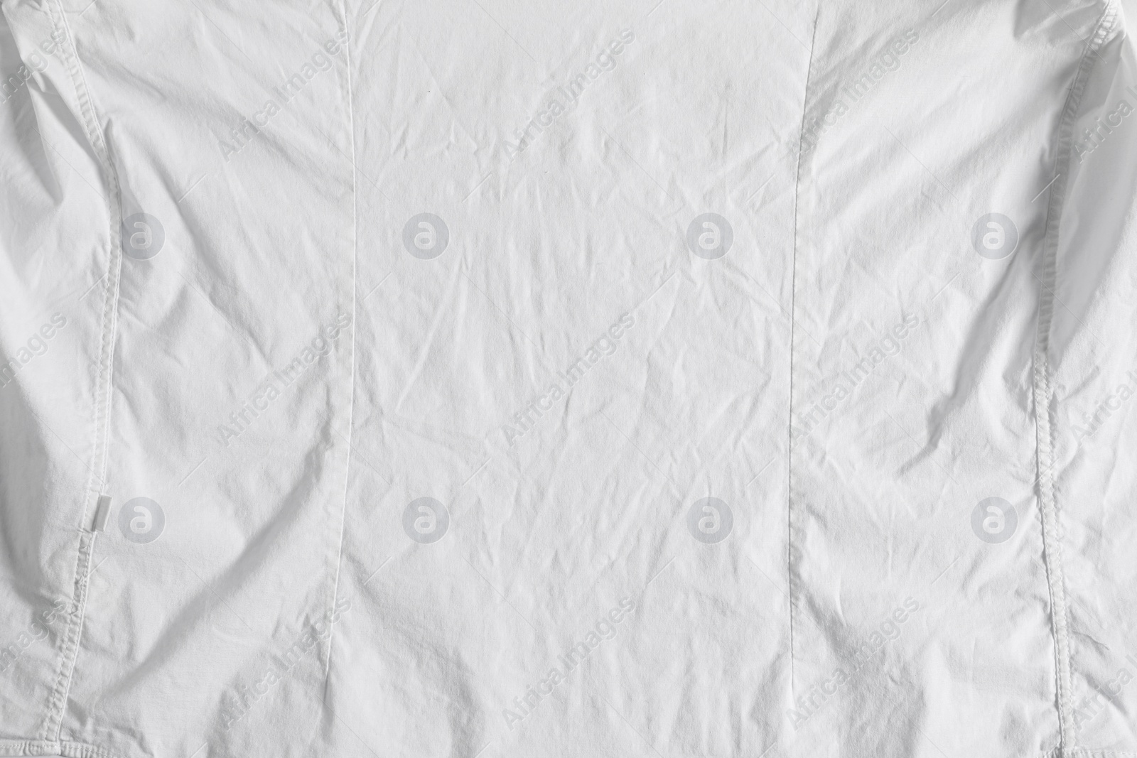 Photo of Crumpled white fabric as background, top view