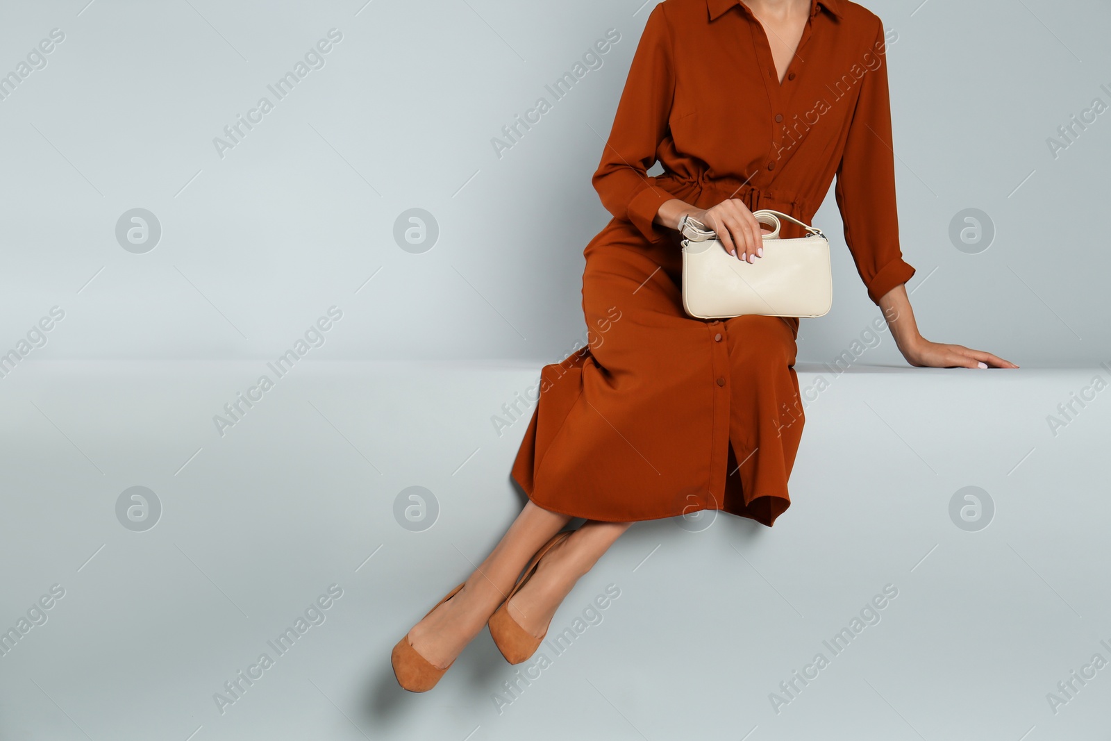 Photo of Woman with stylish bag on grey background, closeup