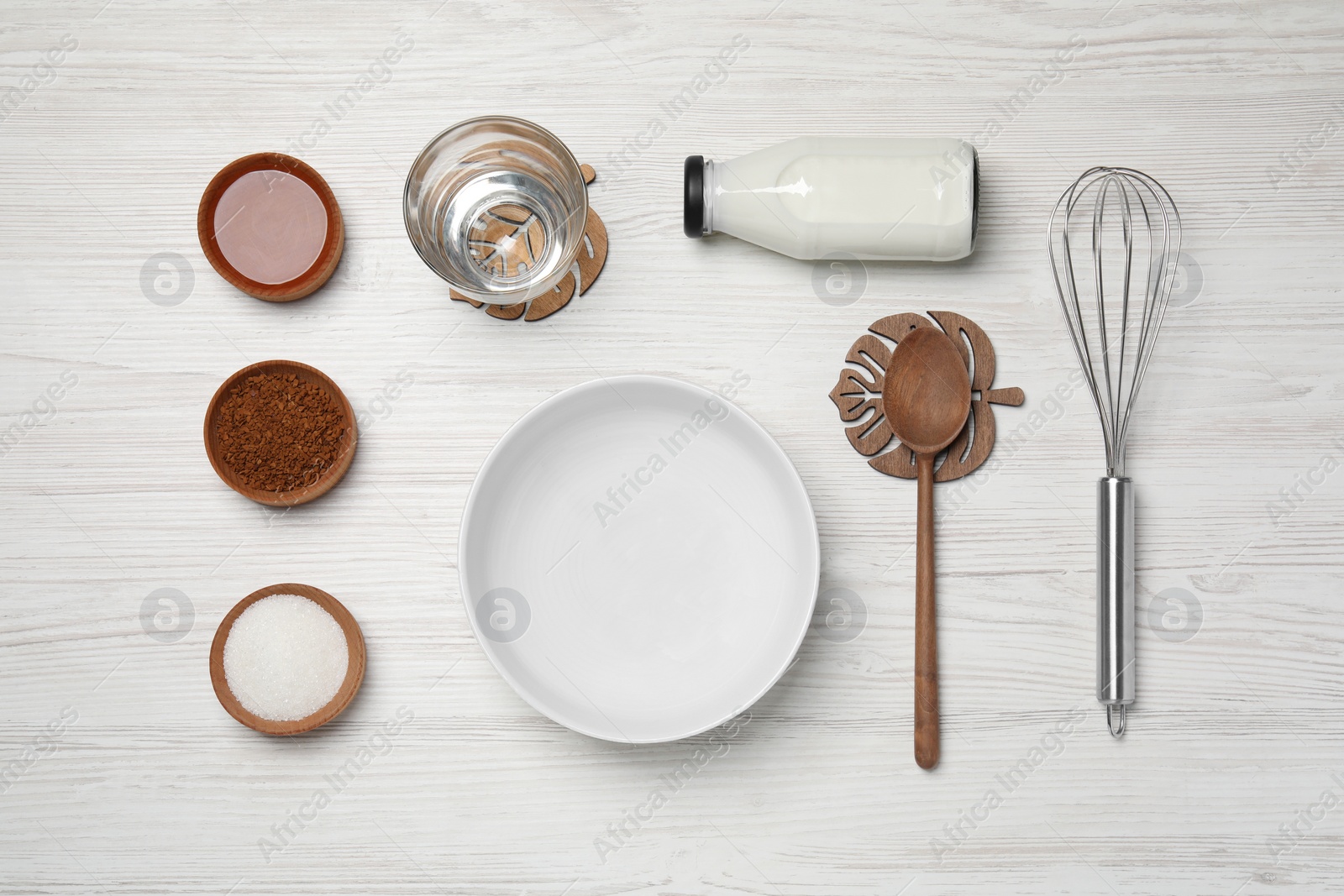 Photo of Flat lay composition with instant coffee granules and whisk on white wooden table