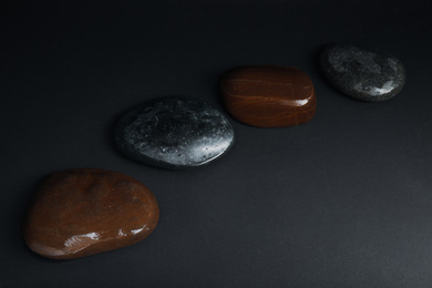 Stones in water on dark background. Zen lifestyle