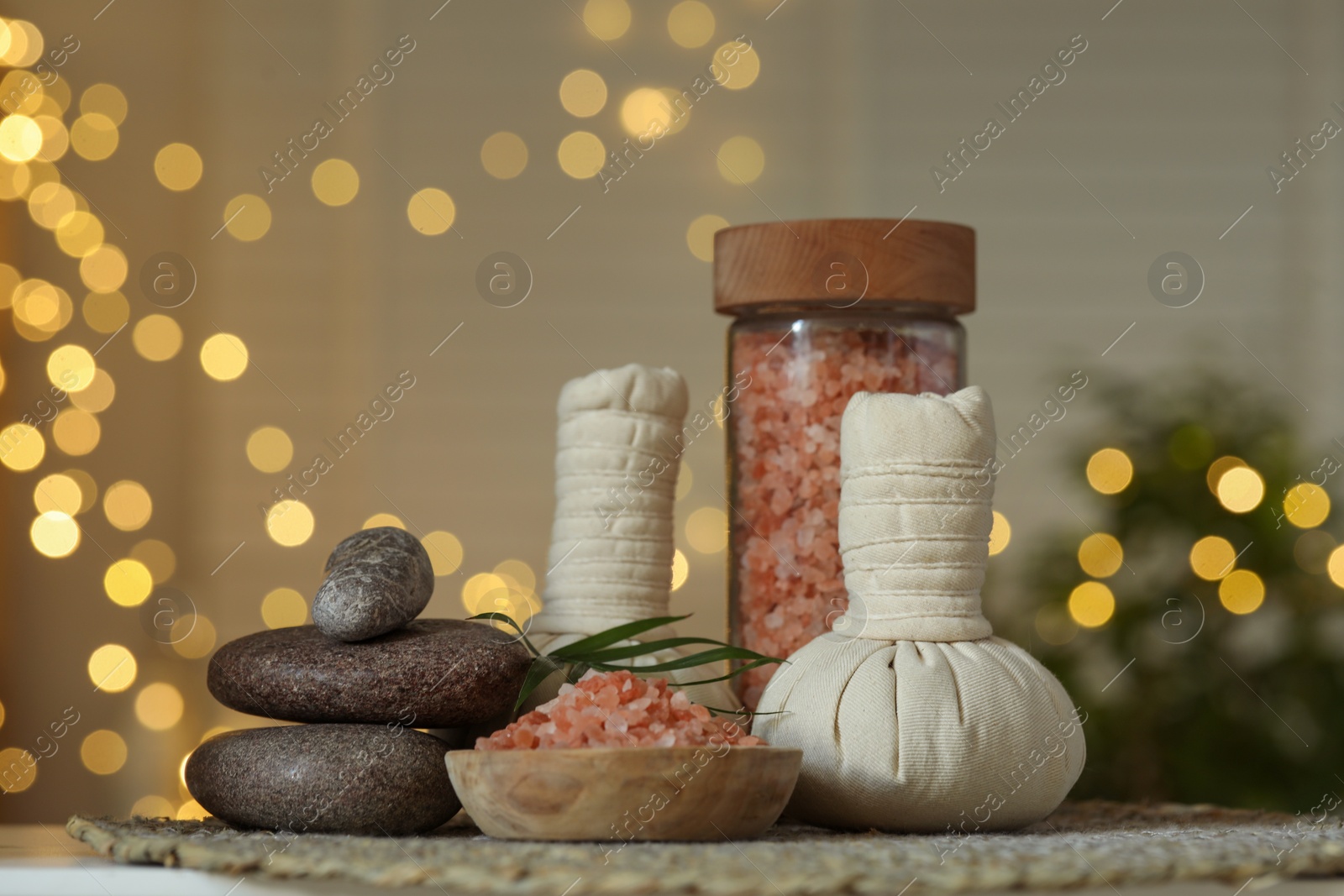 Photo of Composition with different spa products on table indoors, bokeh effect