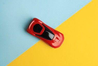 Photo of Red car on color background, top view. Children`s toy
