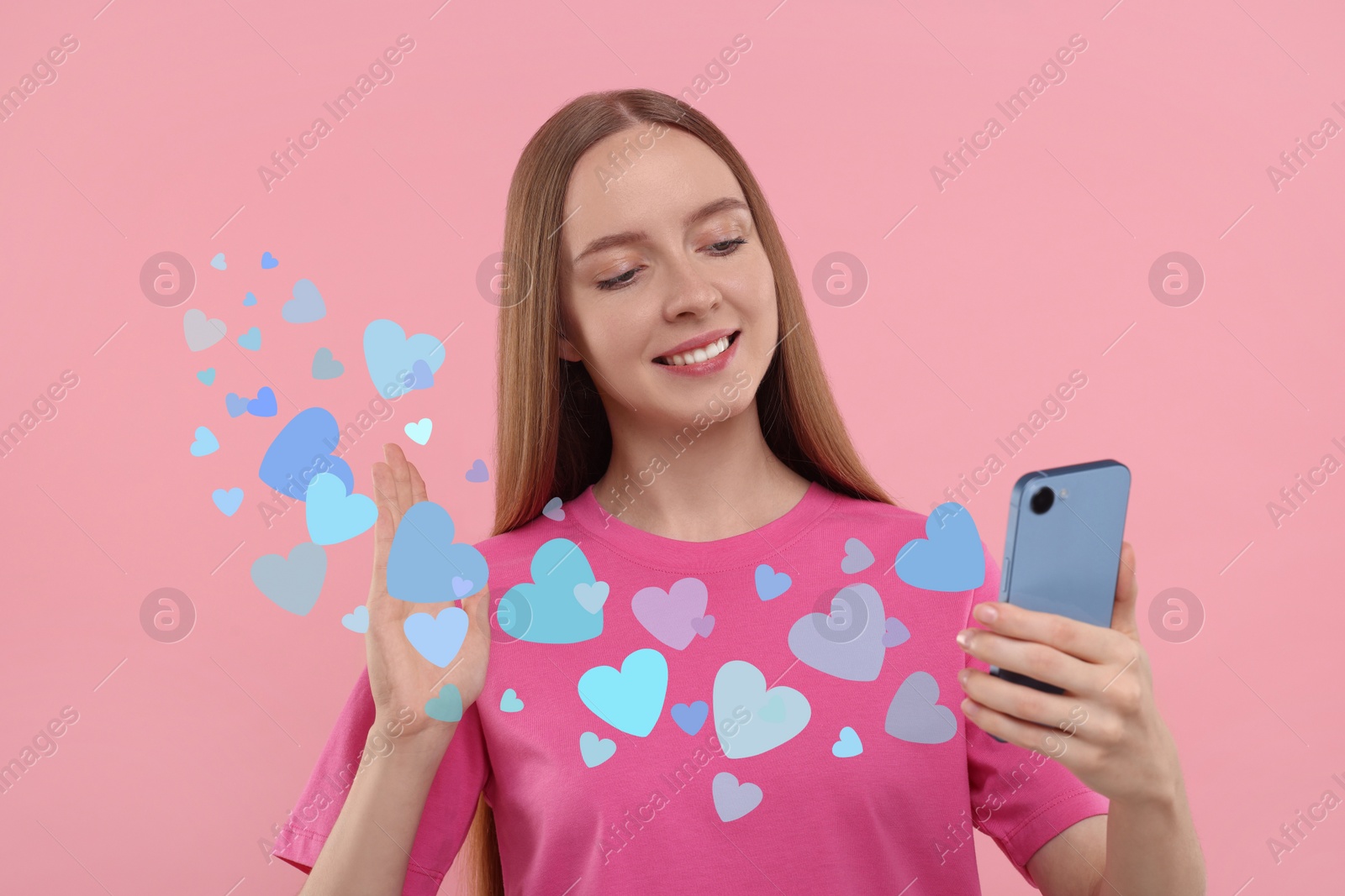 Image of Long distance love. Woman video chatting with sweetheart via smartphone on pink background. Hearts flying out of device