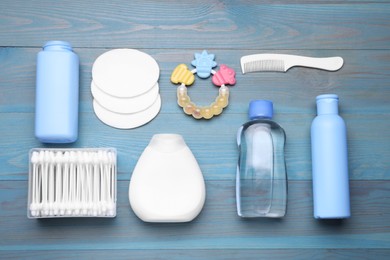 Photo of Flat lay composition with baby care products on light blue wooden table