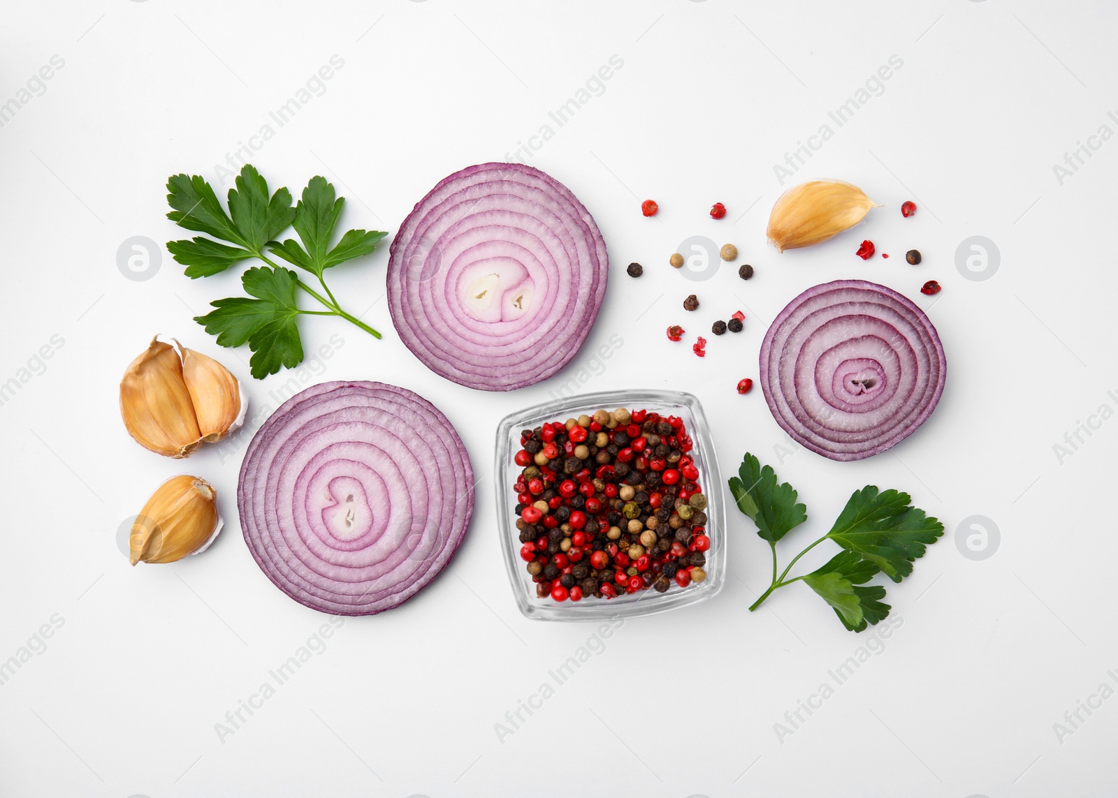 Photo of Fresh red onions, garlic, parsley and spices on white background, flat lay