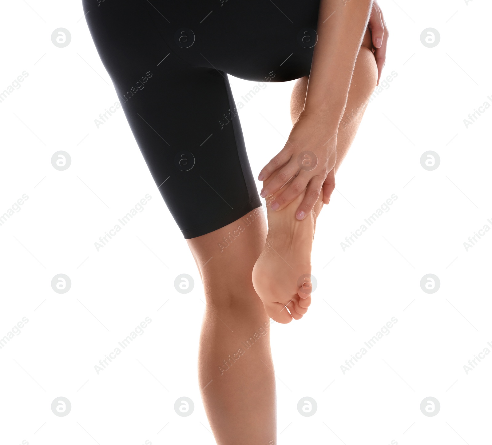 Photo of Back view of woman suffering from foot pain on white background, closeup