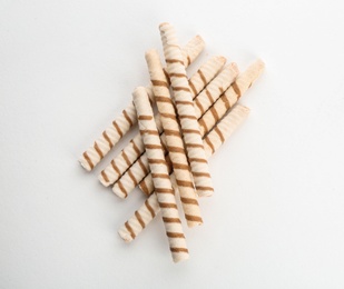 Delicious wafer rolls on white background, top view. Sweet food