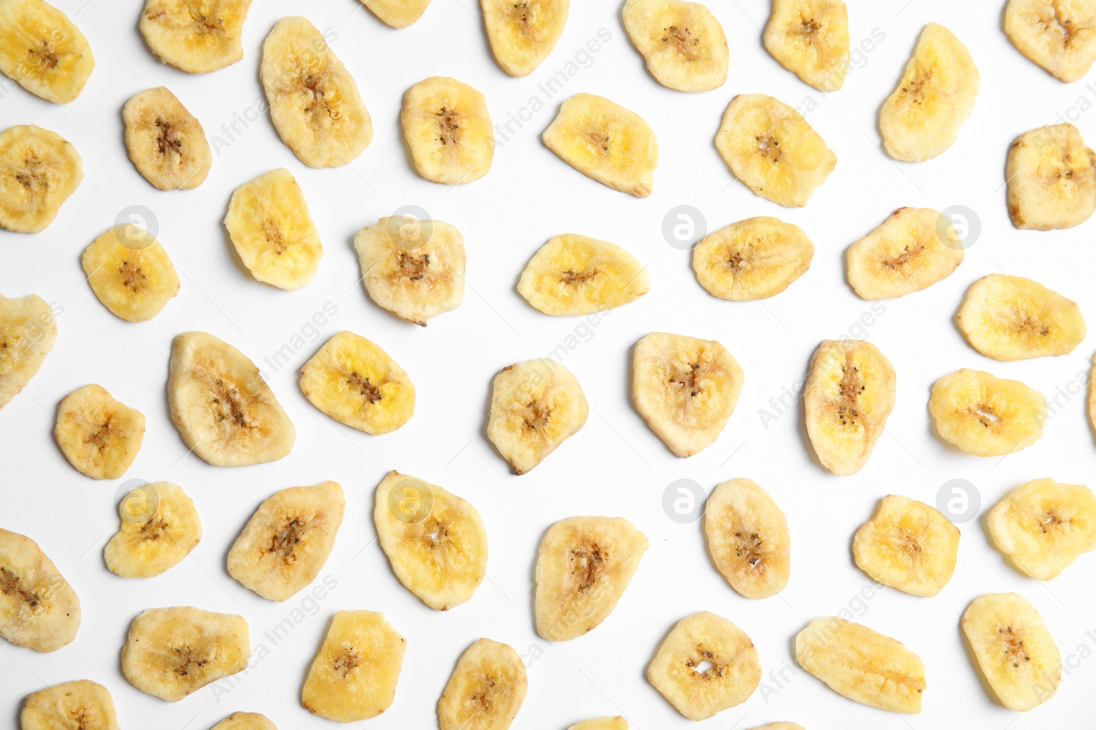 Photo of Flat lay composition with banana slices on  white background. Dried fruit as healthy snack