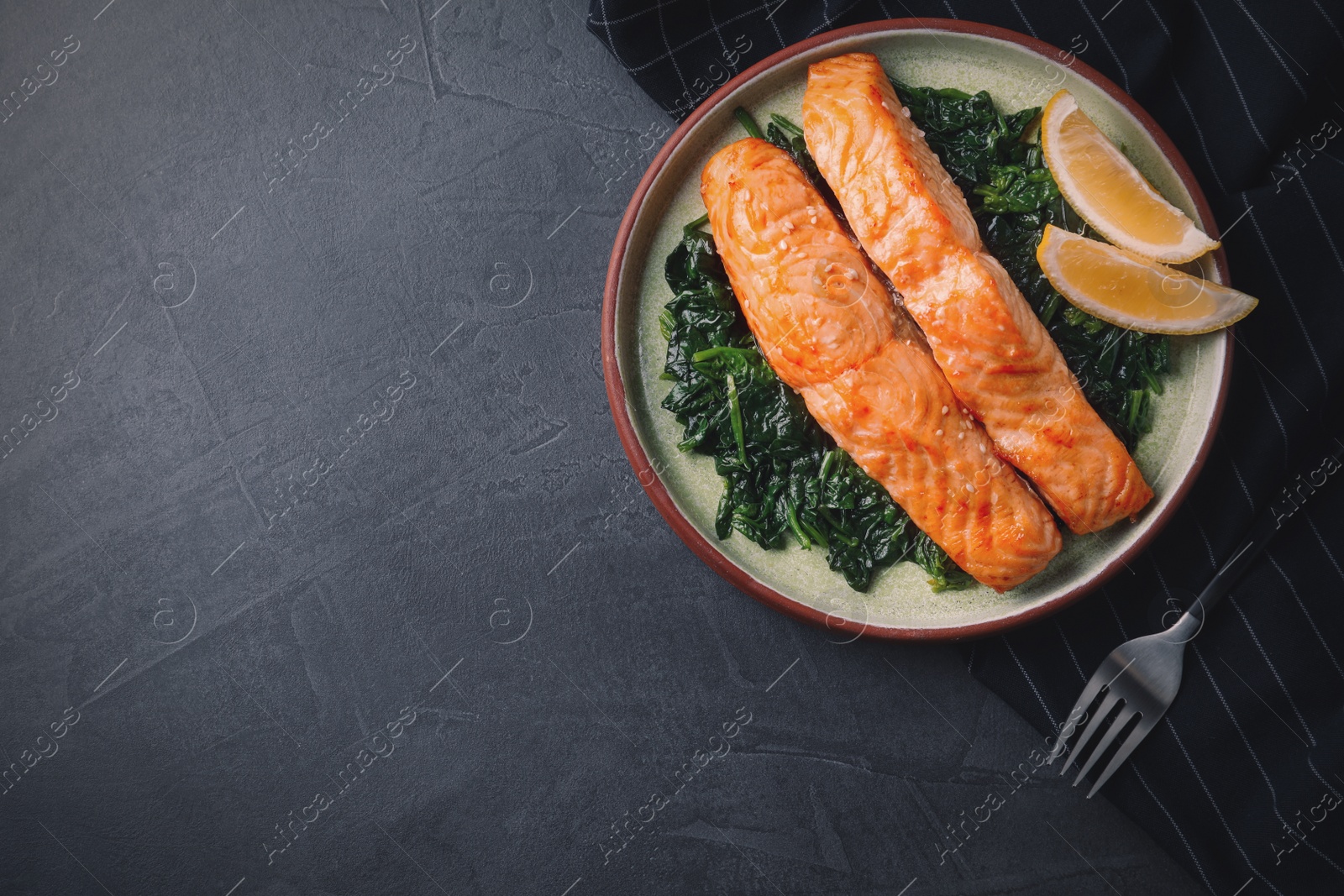 Image of Flat lay composition of tasty salmon with spinach and lemon on grey table, space for text. Food photography  