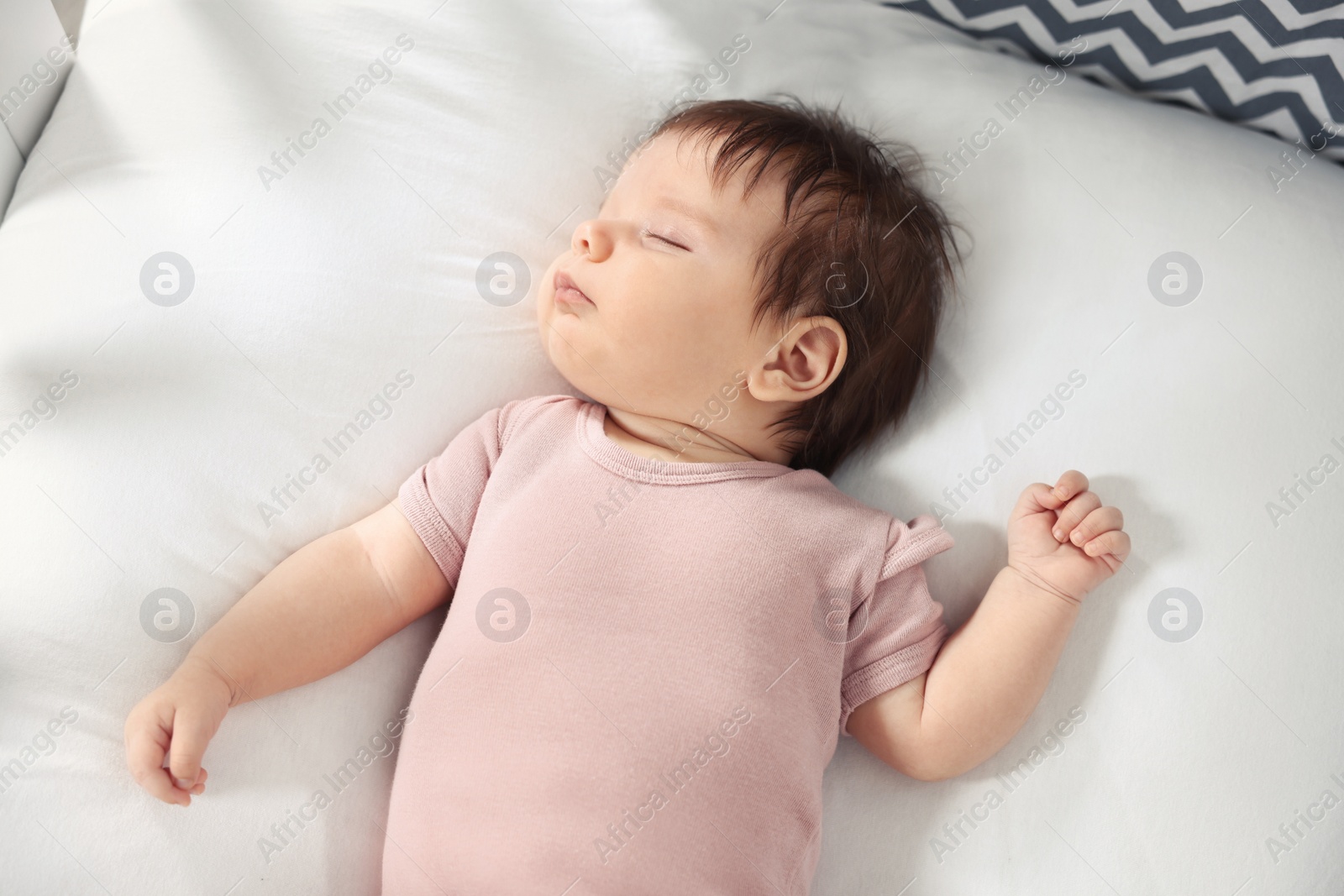 Photo of Cute little baby sleeping on cosy bed