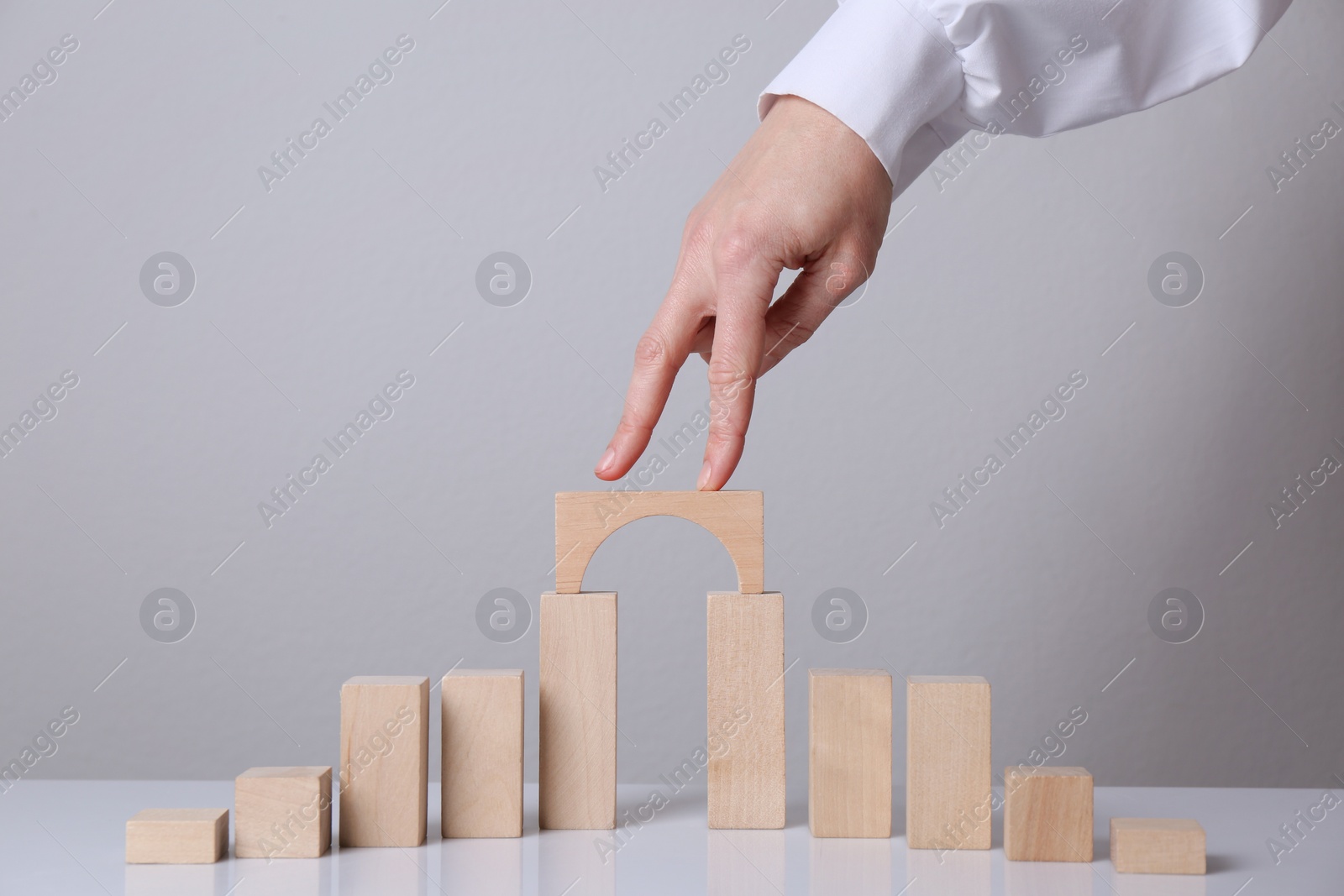 Photo of Woman crossing bridge with her fingers, closeup. Connection, relationships and deal concepts