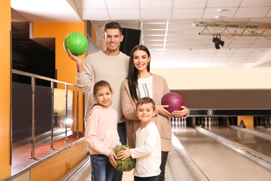 Happy family spending time together in bowling club