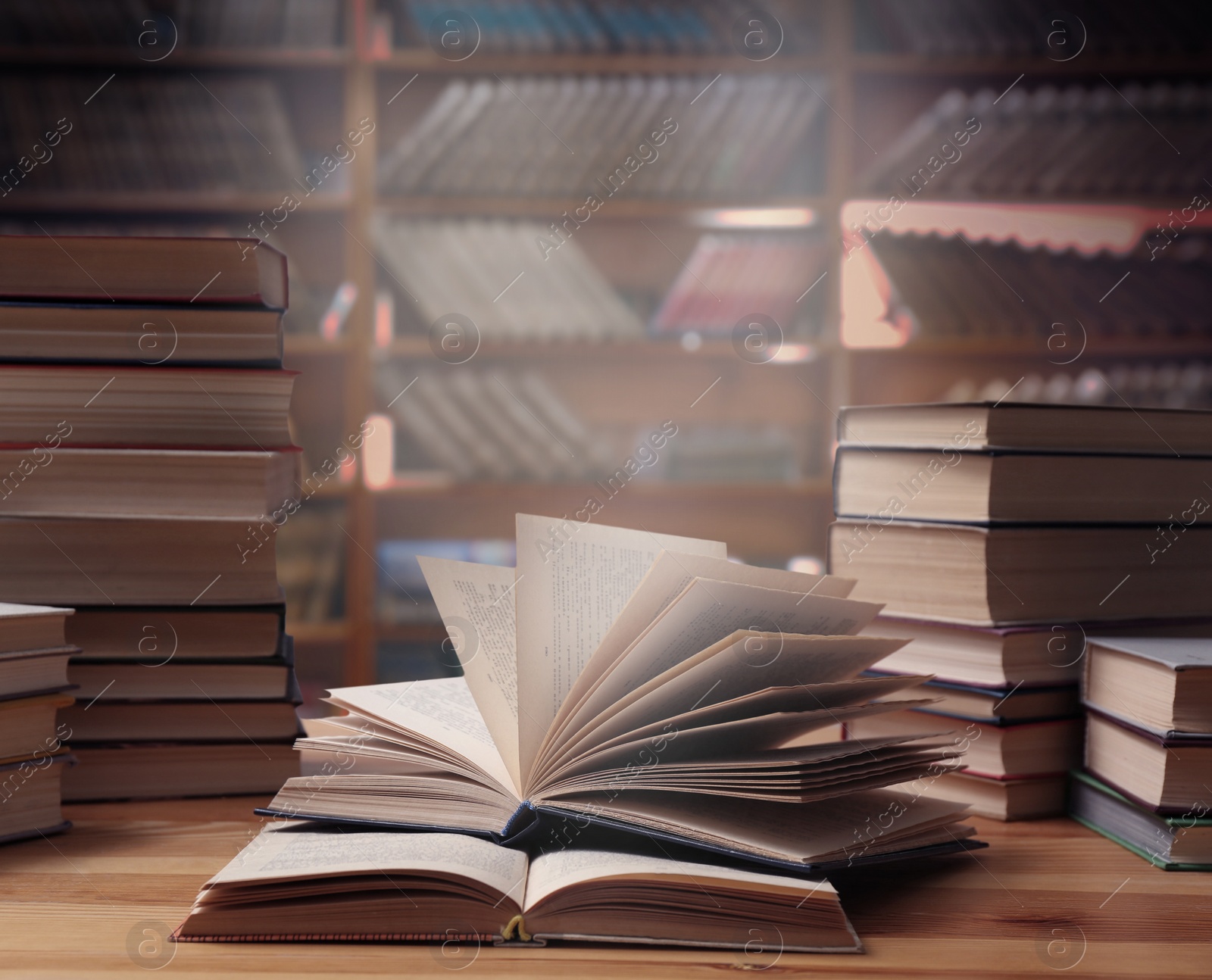 Image of Different books on wooden table in library