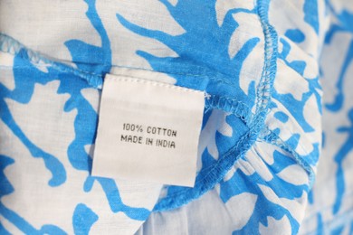 Clothing label on color garment, closeup view