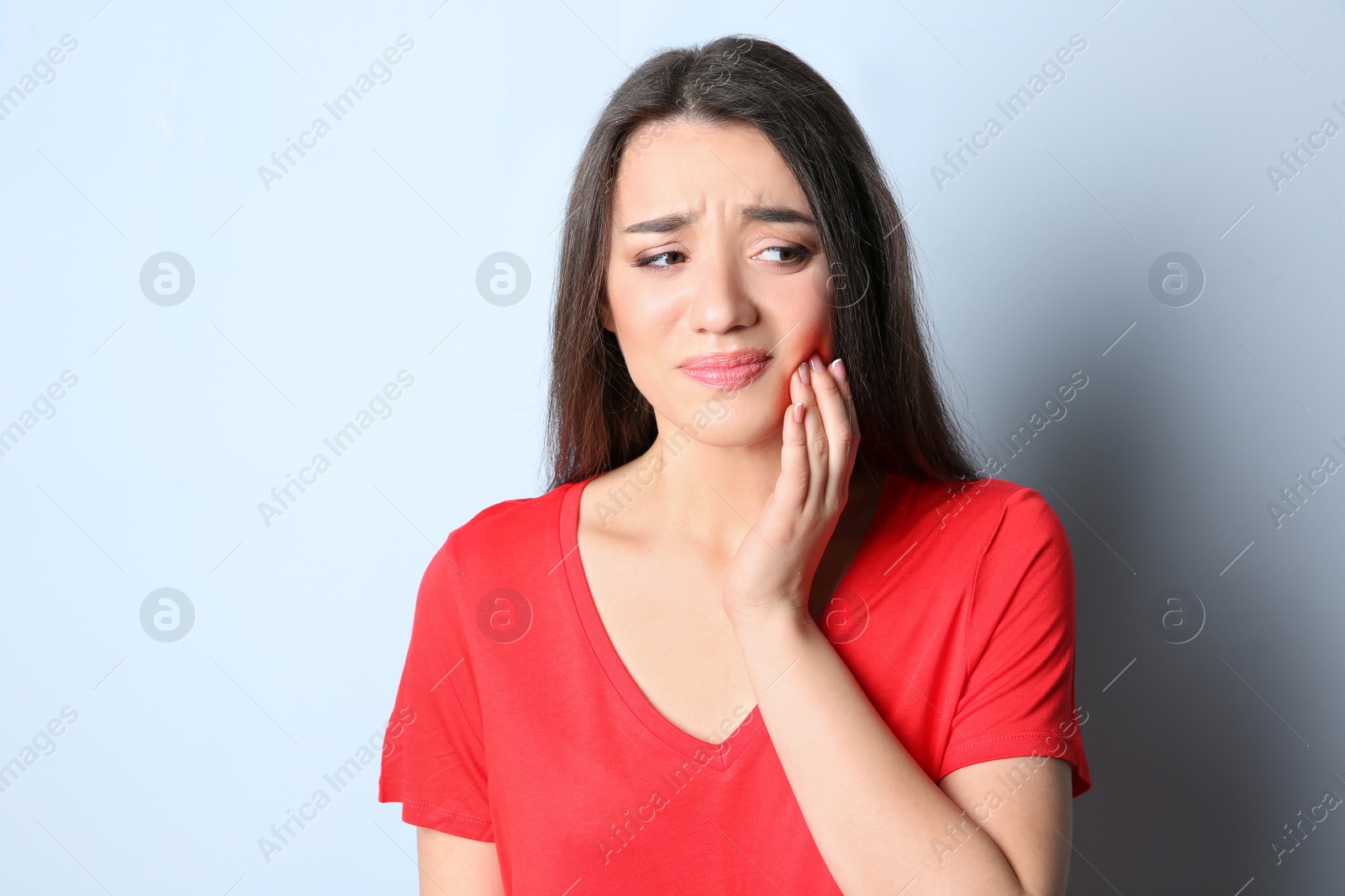 Photo of Woman with sensitive teeth on color background