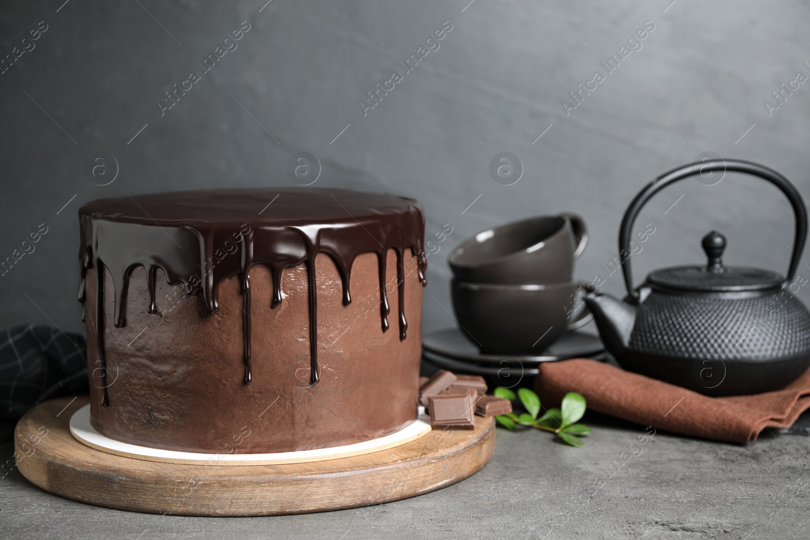 Photo of Freshly made delicious chocolate cake on grey table