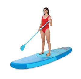 Happy woman with paddle on blue SUP board against white background