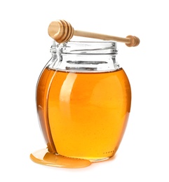 Jar with delicious honey and dipper on white background