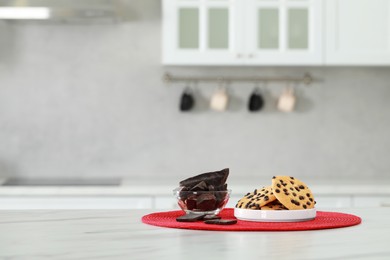 Photo of Delicious chocolate and tasty cookies on white marble table in kitchen. Space for text