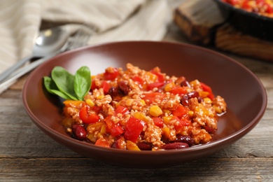 Plate with chili con carne on table