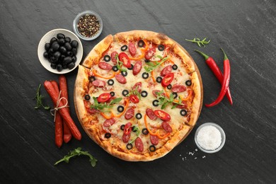 Tasty pizza and ingredients on grey table, top view