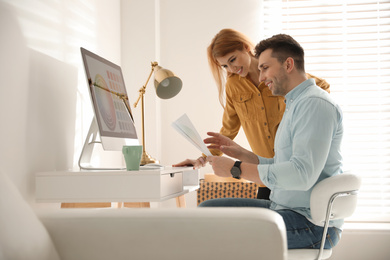 Photo of Professional designers working together in modern office