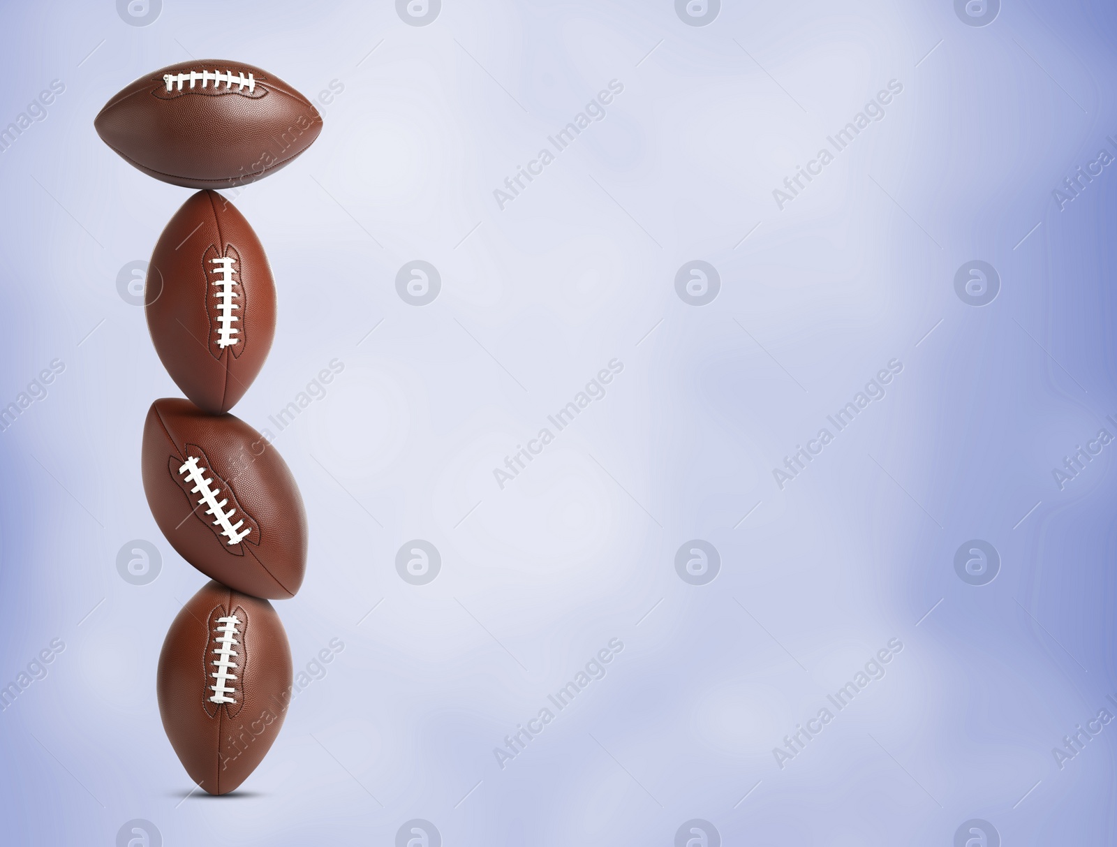 Image of Stack of American football balls on blue background. Space for text