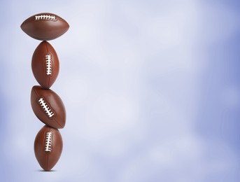 Image of Stack of American football balls on blue background. Space for text