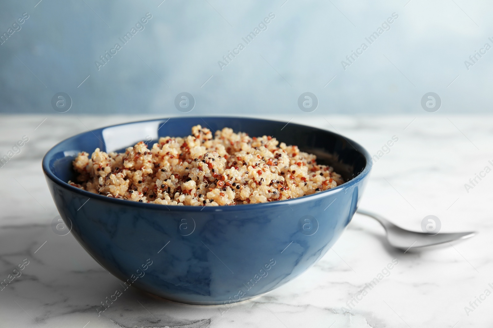 Photo of Cooked delicious quinoa in bowl on table