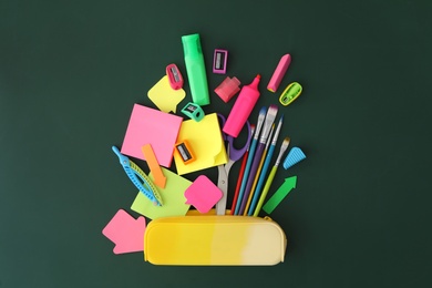 Photo of Flat lay composition with different school stationery on green chalkboard. Back to school