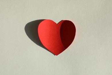 Photo of One paper heart on grey background, top view