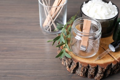 Photo of Composition with homemade candle ingredients on wooden table, space for text