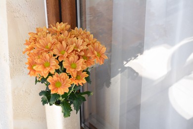 Photo of Bouquet of beautiful chrysanthemum flowers in vase near window outdoors