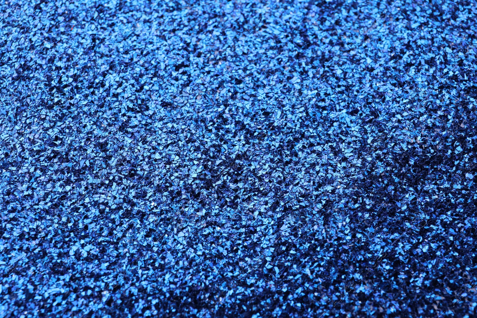 Photo of Beautiful shiny blue glitter as background, closeup