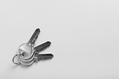 Keys on white background, top view and space for text. Real estate agent services