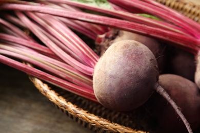 Raw ripe beets in wicker bowl, closeup