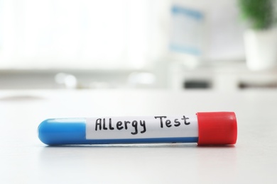 Tube with label ALLERGY TEST on white table