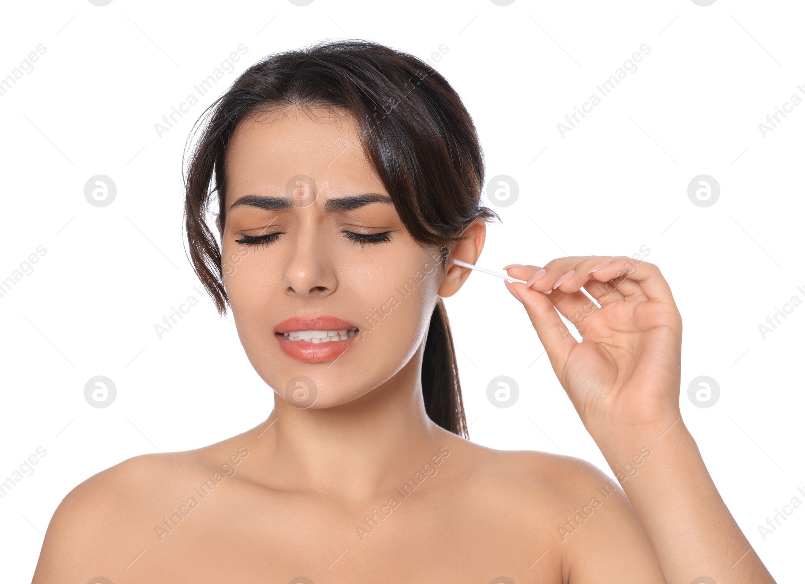 Photo of Young woman cleaning ear with cotton swab on white background