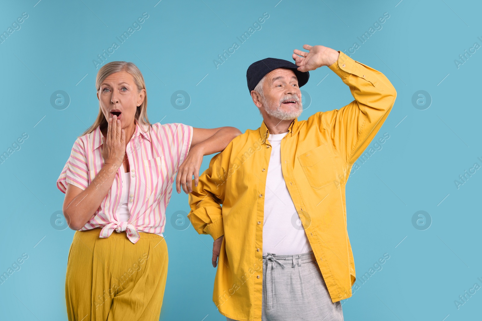 Photo of Senior couple dancing together on light blue background