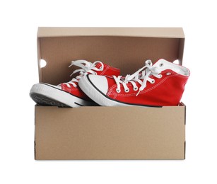 Photo of Pair of stylish sport shoes in cardboard box on white background
