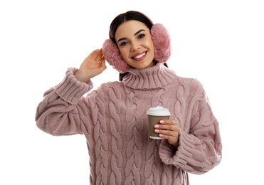 Photo of Beautiful young woman in earmuffs with cup of drink on white background
