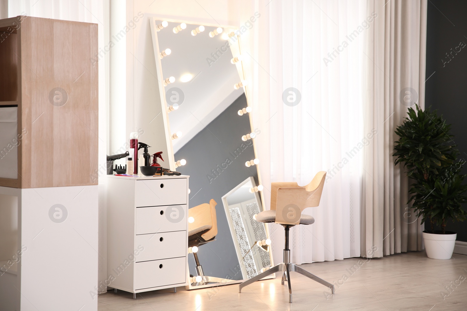 Photo of View of stylish hairdresser's workplace in beauty salon