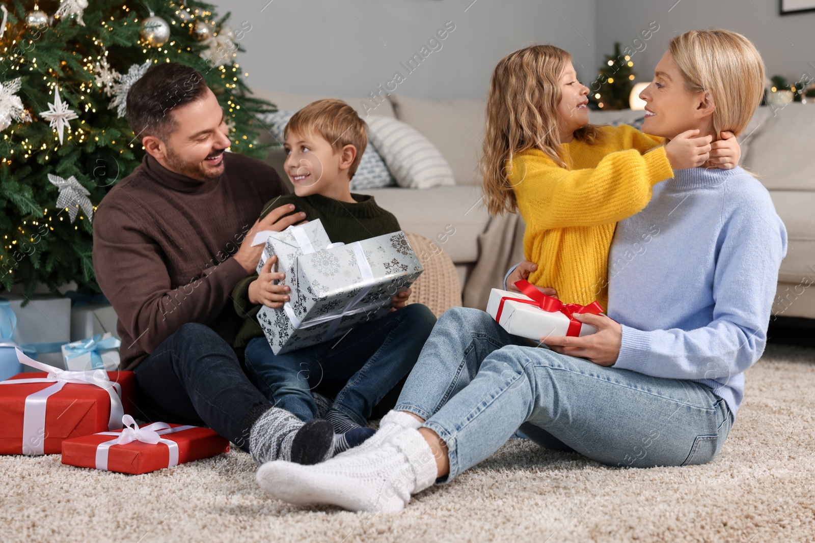 Photo of Happy family with Christmas gifts at home