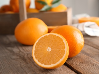 Photo of Fresh juicy oranges on wooden table. Healthy fruits